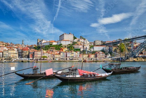 Tableau sur toile Porto rabelo boats moored on Douro River beside Ribeira, Portugal, with traditio