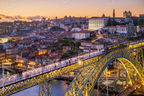 Foto Twilight cityscape of Porto and Ribeira with a tram on illuminated Dom Luis I Br