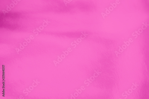 Shiny Pink foil texture background with uneven surface. Abstract bright pink foil background, metal texture wallpaper