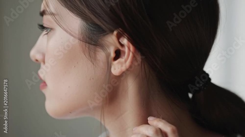 Tense and worried woman face with hand on face looking sideways in expression of anxiety and insecurity