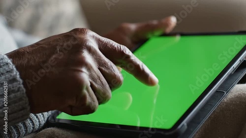 Elderly Person Interacting with Green Screen Tablet for Content Creation