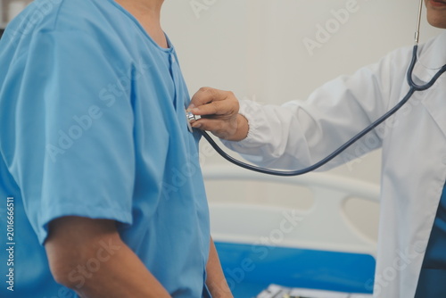 Принти на полотні Doctor using stethoscope to examine patient chest during medical consultation in
