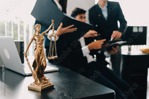 Fotografie Professional lawyers discussing legal documents in modern office with justice st