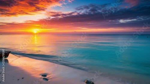 Beach sunset with colorful sky and calm sea a small boat rests on the shore