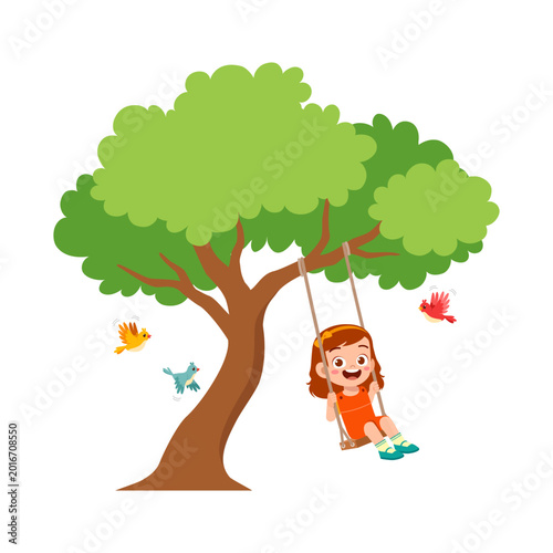 A happy Asian little girl smiling broadly enjoying swinging on a tree swing surrounded by flying birds