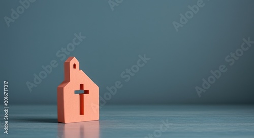 Small wooden church block with cross cutout standing on a neutral surface for religious community branding, faith-based app hero images and spiritual storytelling