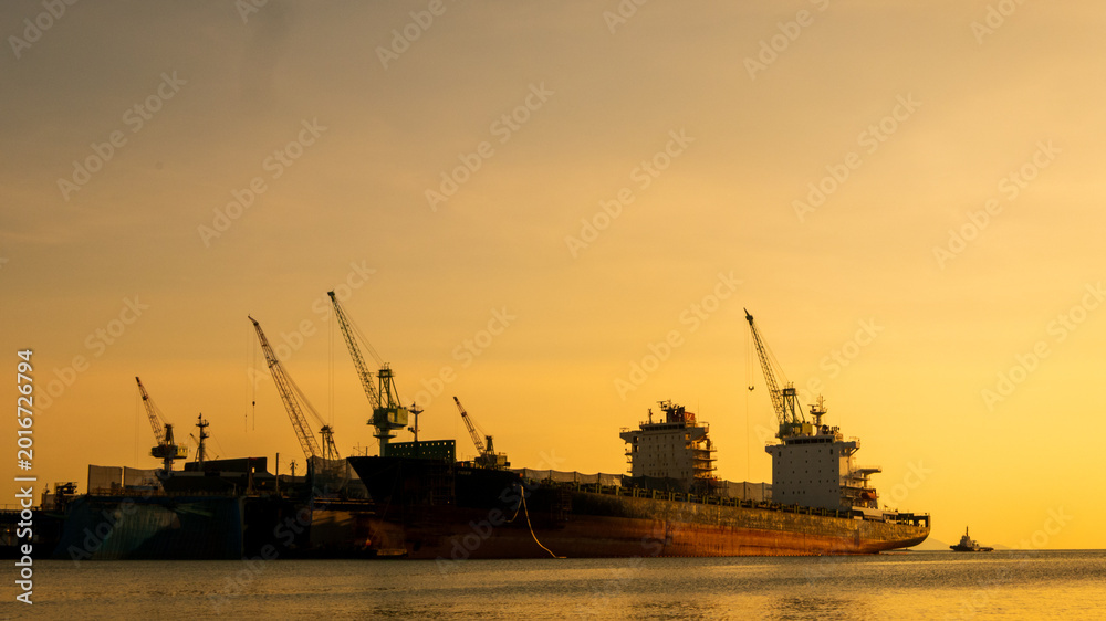 Fototapeta premium Logistics seascape shipping portal. Logistic shipping quay boat Engineering crane depot at logistic export terminal control. . Logistic shipping quay boat in twilight sky night Engineering crane