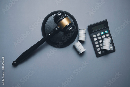 Legal Gavel with Calculator and Oil Barrels Representing Energy Litigation and Fuel Industry Regulations