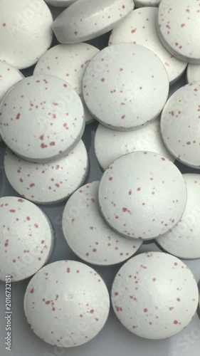 Close-up of a scattering of pills. Vertical video.