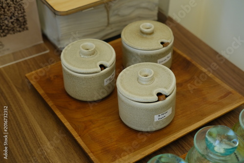 Three Ceramic Salt Jars with Wooden Spoons on Wooden Tray