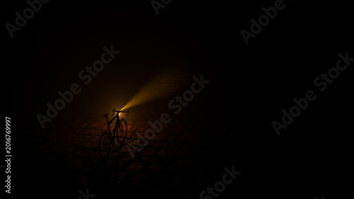 A bicycle with headlight and its light beam on a dark cobble stone road at night (3D Rendering)