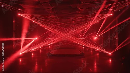 A dark room with multiple red laser lights.