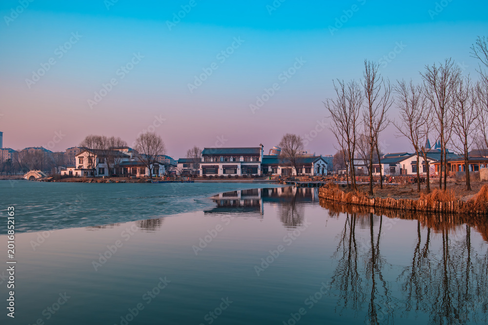 Fototapeta premium Hailong Lake Scenic Area in Meihekou – Ecological Wetland and Urban Park Landscape with Lakeside Recreation, Commercial Street and Public Leisure Spaces, China – April 2, 2026