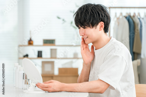 Obraz na plátně A young Asian man is delighted that his skin problems have been resolved and alleviated through skincare
