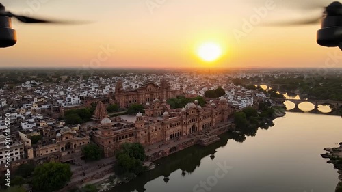 Beautiful City Skyline at Sunset with Bright Sun and Orange Golden Glow on Horizon