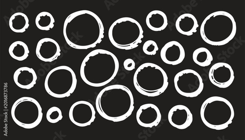 Photos Set of black uneven circles drawn with thick outline by hand with paint brush with smeared, rough edges of different sizes