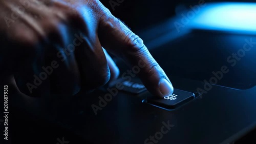 A finger presses the power off button with dramatic blue lighting and a mood of finality
