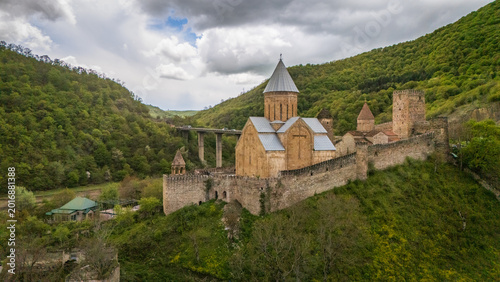 aerial of stone masonry and ancient walls of the Ananuri Fortress church, showcasing the intricate medieval architecture and traditional tiled roofs in the heart of Georgia