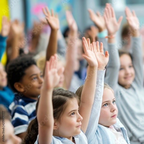 Children Raise Hands in Classroom During Lesson to Participate and Share Idea...