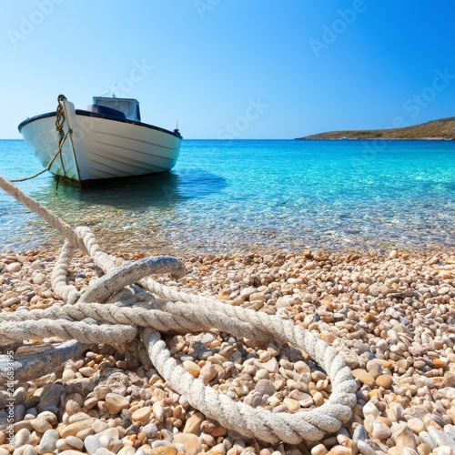 Boats Anchored at a Beach With Clear Water and Bright Sun During Daytime