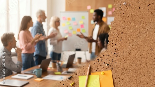 Diverse Team Collaboration in Modern Office Space with Post-it Notes on Board