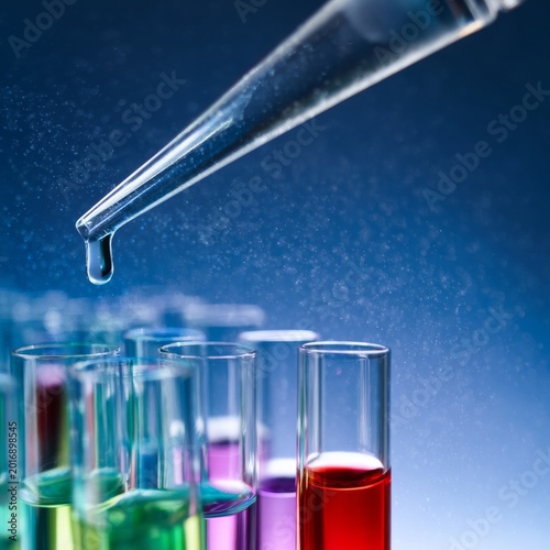 Laboratory Technician Uses Dropper to Add Liquid to Test Tubes During Scienti...