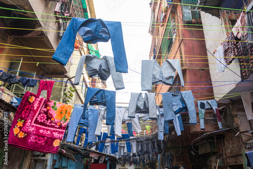 Photography After the ring-dyeing process jeans trousers are hanging in the sun to dry in a street for lasting colour