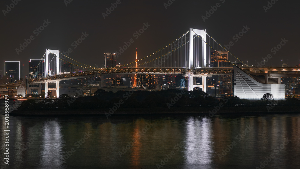 Fototapeta premium Night View of Suspension Bridge with City Lights and Reflections
