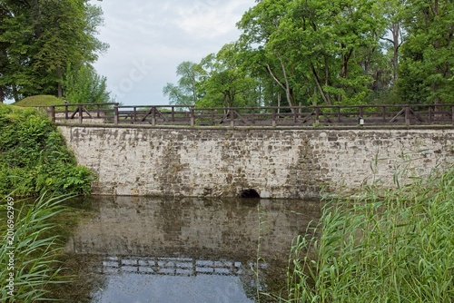 Photos Scenic stone bridge situated in a lush, green park environment in cloudy summer weather, Kuressaare, Saaremaa, Estonia, Europe