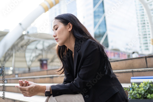 Картината върху платно Asian businesswoman feeling sad and discouraged after losing her job