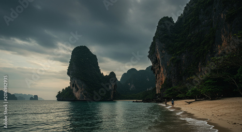 Scenic Coastal Landscape with Dramatic Cloudy Sky and Tall Green Rock Formations