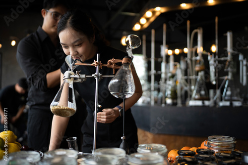 Photos Asian Perfumers Creating Fragrance in Modern Laboratory with Botanical Ingredien