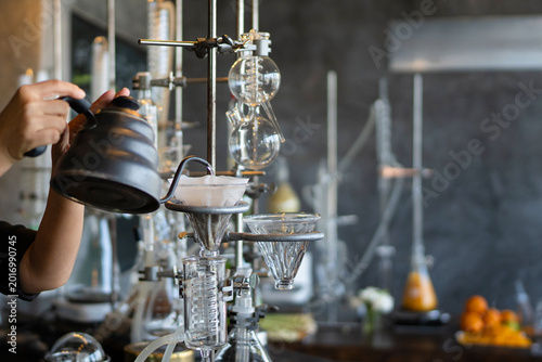 Obraz na plátně close up hand barista skillfully brews specialty coffee using a gooseneck kettle