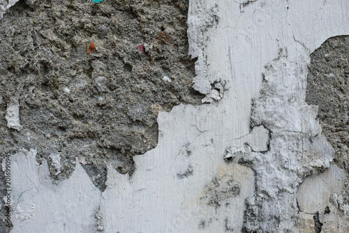 Konstfotografi Rough wall detail with thick plaster damage and peeling paint layers in gray and white tones