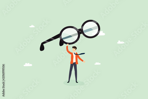 Businessman holding giant eyeglasses for business vision and clarity concept