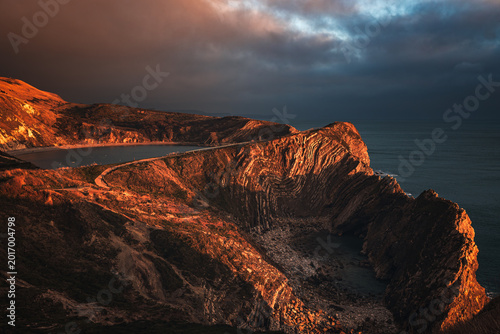 Canvastavla Stair Hole and Lulworth Cove in West Lulworth, Dorset, England at sunset with a