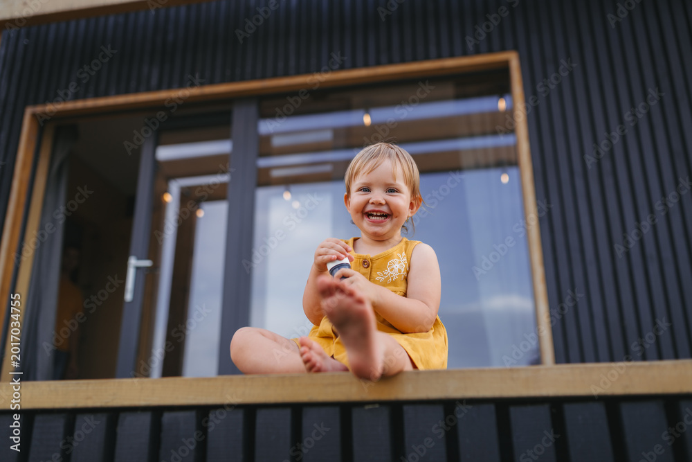 Fototapeta premium Small child playing outdoors, weekend away in container house in countryside.