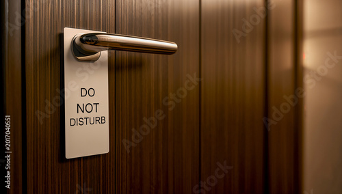 Do Not Disturb Sign Hanging on Hotel Room Door Handle, Offering Privacy and Peace