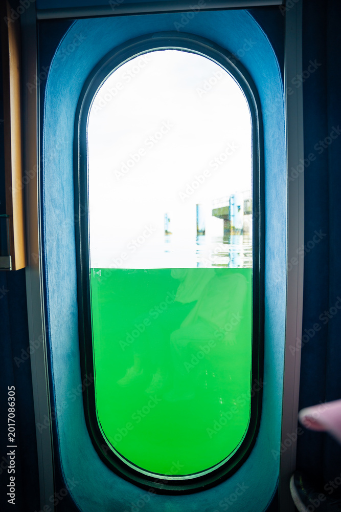 Fototapeta premium Underwater observation window inside the diving gondola at Sellin Pier in the Baltic Sea on Rugen island, Germany. Marine exploration and immersive travel experience concept.