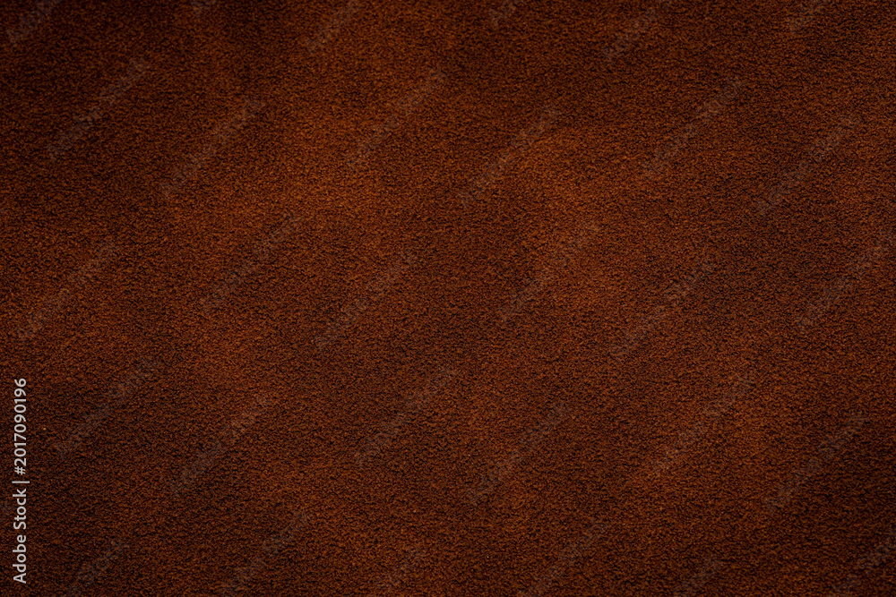 Fototapeta premium Closeup of brown suede texture for background and design Dark brown suede texture with fine detail, perfect for backgrounds and upholstery