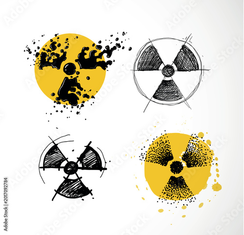 Obraz na plátne Set of four hand-drawn radioactive symbols in different styles: liquid splash, scribble, sketch and stipple on yellow watercolor