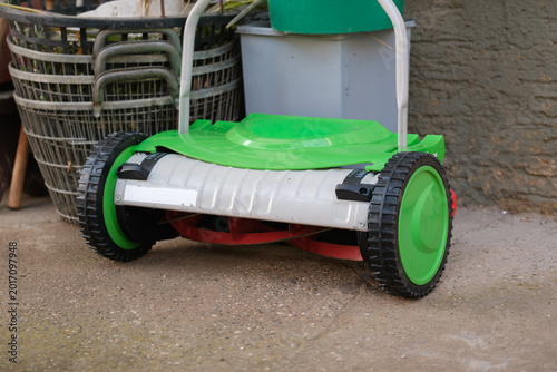 Bild auf Leinwand Modern lawn mower on a concrete platform near the house