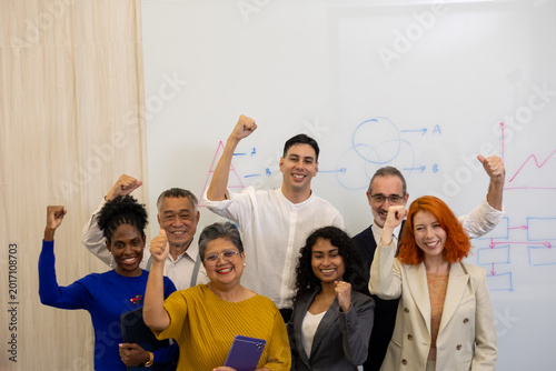 Bild auf Leinwand Portrait of a diverse, multi-ethnic corporate business team standing confidently together in a modern office meeting room in front of a whiteboard