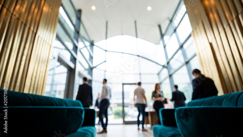 Business people networking in a bright modern corporate lobby
