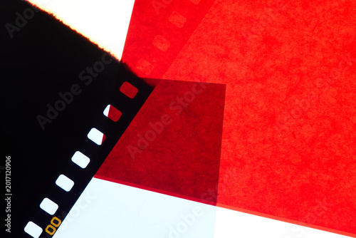 Photo. Copy space background with black and red transparent film strip perforation. Vintage background, technology, photography, art. 