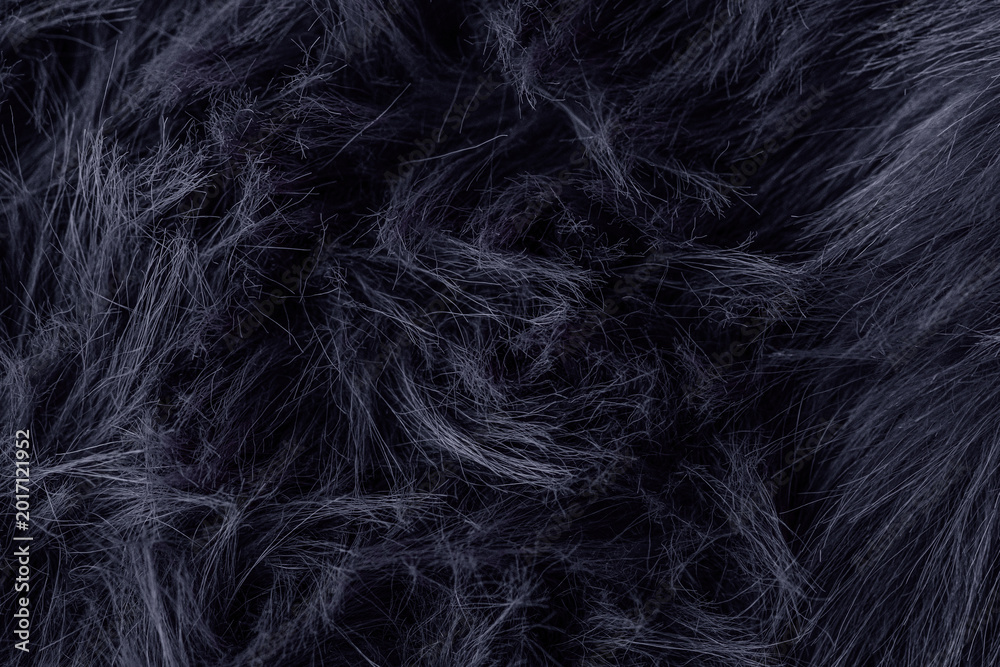Naklejka premium Dark fluffy faux fur material texture offering a soft deep luxurious and warm background