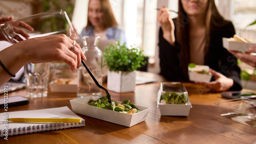 Konstfotografi Office workers eating salads together during lunch break