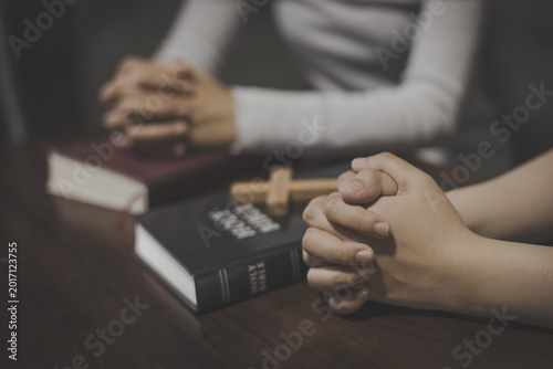 Φωτογραφία Christian group of people holding hands praying worships together to believe and Bible on wooden table for devotional for prayer meeting
