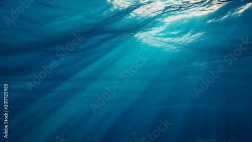 Underwater View of Sunbeams Piercing Through Ocean Surface