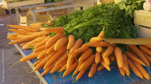 Organic carrots with green leaves close up